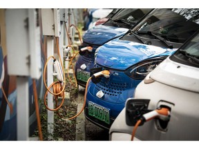 SAIC-GM-Wuling Automobile Co. electric vehicles are plugged in at charging stations at a roadside parking lot in Liuzhou, China, on Monday, May 17, 2021.  Photographer: Qilai Shen/Bloomberg