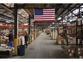 A U.S. flag in a warehouse at the Fiesta Tableware Co. factory in Newell, West Virginia, U.S., on Thursday, July 22, 2021. Markit is scheduled to release manufacturing figures on August 2. Photographer: Luke Sharrett/Bloomberg