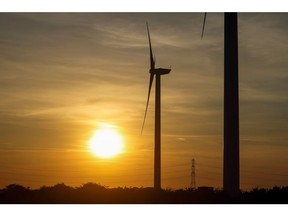 The sun sets behind onshore wind turbines on the Bradwell Wind Farm near Bradwell-on-sea, U.K., on Tuesday, Sept. 21, 2021. Photographer: Chris Ratcliffe/Bloomberg