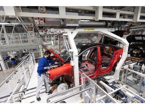 An employee works on Volkswagen ID.5 electric sports utility vehicles (eSUV) on the assembly line during a media tour of the automaker's electric automobile factory in Zwickau, Germany, on Thursday, Jan. 27, 2020. On Dec. 9, Chief Executive Officer Herbert Diess, delivered his largest plan yet for electrification, allocating 89 billion euros ($100 billion) to EV and software development over the next half decade.