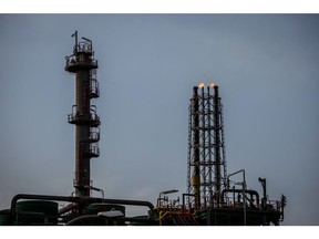 Flame stacks burn, right, at Repsol SA's Cartagena oil refining complex in Cartagena, Spain, on Thursday, Jan. 27, 2022. Oil is headed for a sixth straight weekly gain, with prices trading near a seven-year high as crude makes a roaring start to 2022. Photographer: Angel Garcia/Bloomberg