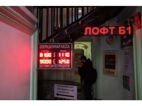 A sign displays foreign currency exchange rates to the Russian ruble at an exchange bureau in Moscow, Russia, on Monday, Feb. 28, 2022. The Bank of Russia acted quickly to shield the nation's $1.5 trillion economy from sweeping sanctions that hit key banks, pushed the ruble to a record low and left President Vladimir Putin unable to access much of his war chest of more than $640 billion. Photographer: Andrey Rudakov/Bloomberg