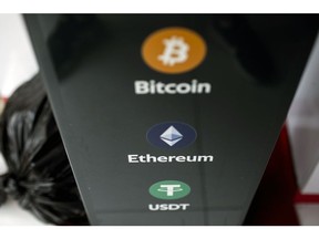 Logos for Bitcoin, top, Ethereum, center, and Tether on a cryptocurrency automated teller machine (ATM) at a laundromat in Hong Kong, China, on Friday, March 18, 2022. Bitcoin had spent the past few days mired in the tightest trading range since October 2020, a phenomenon some market watchers ascribed to long-term holders stepping in to buy whenever the token dips. Photographer: Paul Yeung/Bloomberg