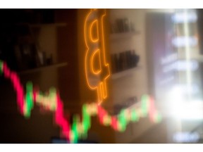 A reflection of a candlestick price chart and an illuminated Bitcoin logo inside a BitBase cryptocurrency exchange in Barcelona, Spain, on Monday, May 16, 2022. The wipeout of algorithmic stablecoin TerraUSD and its sister token Luna knocked more than $270 billion off the crypto sector's total trillion-dollar value in the most volatile week for Bitcoin trading in at least two years. Photographer: Angel Garcia/Bloomberg