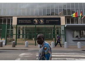 Pedestrians pass by headquarters for the African Development Bank (AfDB) in the Plateau business district of Abidjan, Ivory Coast, on Monday, May 16, 2022. Surging international food prices will hit Africa's economies the hardest and may trigger social unrest if governments fail to cushion the blow, according to a report by Oxford Economics Africa.