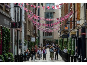 Shoppers walk along a street in Covent Garden, London, UK, on Wednesday, May 18, 2022. Britain's worst bout of inflation in 40 years is quickly becoming a crisis both for Prime Minister Boris Johnson's government and the Bank of England.