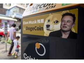 A sticker advertising Dogecoin on a cryptocurrency automated teller machine (ATM) at a laundromat in Hong Kong, China, on Thursday, June 9, 2022. Tesla Inc. Chief Executive Elon Musk expressed his interest in Bitcoin and Dogecoin early last year and allowed Tesla customers to buy the electric cars with Bitcoin, helping to send the crypto market to record highs.