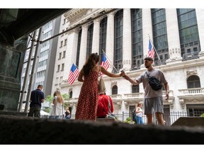 NEW YORK, NEW YORK - JUNE 14: People walk outside of the New York Stock Exchange (NYSE) in the financial district in Manhattan on June 14, 2022 in New York City. The Dow was up in morning trading following a drop on Monday of over 800 points, which sent the market into bear territory as fears of a possible recession loom.