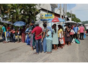 People wait in line to buy kerosene at a gas station in Kandy, Sri Lanka, on June 13.