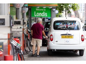 A customer fills their taxi at a Texaco Inc. petrol station in London, UK, on Monday, June 13, 2022. Last week, UK fuel prices surged by the most in 17 years to underscore the inflationary pressures the country faces.
