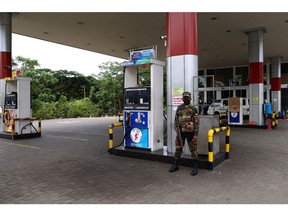 A soldier guards a fuel pump after a gas station ran out of gasoline in Kandy, Sri Lanka, on Friday, June 17, 2022. The government of Sri Lanka declared Friday a holiday for public offices and schools to curtail vehicular movement as the country, facing its worst financial crisis, runs out of fuel for transport and there's little signs of fresh supplies coming in.
