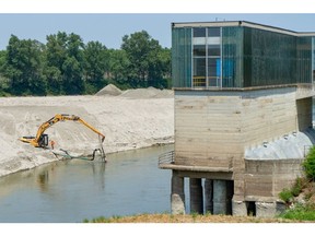 An excavator lowers the riverbed level of the Po river, so that water reaches the hydraulic pumps of an irrigation system, in Boretto, Italy, on June 17. Photographer: Francesca Volpi/Bloomberg