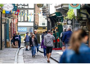 Shoppers walk along a retail street in the city centre of York, UK, on Monday, June 20, 2022. On Wednesday, inflation is set to rocket to a new 40-year high with the cost of goods leaving factories already racing ahead at a double-digit pace.