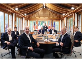 G-7 leaders prior to a discussion on June 28. Photographer: Liesa Johannssen-Koppitz/Bloomberg