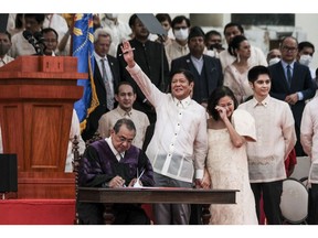 Ferdinand "BongBong" Marcos Jr., the Philippines' president, waves during a swearing-in ceremony at the Old Legislative Building in Manila, the Philippines, on Thursday, June 30, 2022. Marcos won the presidency by a landslide with a campaign that promised unity and pandemic recovery, and which got a boost from social media posts positively portraying the dictatorship despite economic downturn and human rights violations at that time.