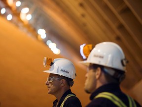 Employees stand in a storage barn at the Nutrien Ltd. Cory potash facility in Saskatoon, Saskatchewan. Nutrien is ramping up production amid a global shortage.