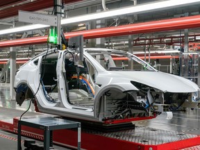 ars are seen on the assembly line during a tour of the Tesla Giga Texas manufacturing facility in Austin, Texas.