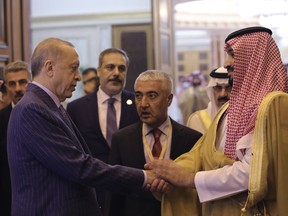FILE - In this photo made available by the Turkish Presidency, Turkish President Recep Tayyip Erdogan, left, and Saudi Arabia's Crown Prince Mohammed bin Salman speak after their meeting in Jiddah, Saudi Arabia, April 29, 2022. Saudi Crown Prince is scheduled to arrive in Ankara on Wednesday, June 22, 2022 making his first visit to Turkey as the two regional heavyweights press ahead with efforts to repair ties following the slaying of Saudi columnist Jamal Khashoggi in Istanbul. (Turkish Presidency via AP, File)