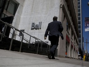 A pedestrian walks past a Bell Canada office in Toronto.