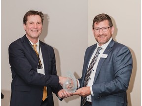 Photo caption:Cleanfarms Executive Director Barry Friesen accepts the Cam Davreux Stewardship Award from CropLife Canada's President and CEO, Pierre Petelle. – CropLife Photo