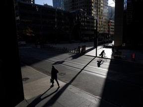 A commuter in Toronto's financial district. Workers say they've seen many benefits from hybrid work.