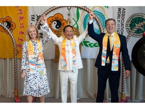 From left, Dr. Katrina Lantos Swett, president of the Lantos Foundation for Human Rights and Justice; Dr. Hong, Tao-Tze, zhang-men-ren (grandmaster) of Tai Ji Men and president of the Federation of World Peace and Love (FOWPAL); and former U.S. Ambassador-at-Large for International Religious Freedom Sam Brownback, right, hold hands to show solidarity for the promotion of love and peace in the world after Dr. Swett's and Amb. Brownback's ringing the Bell of World Peace and Love in Washington, D.C. on June 28, 2022. (Kevin Wolf/AP Images for Federation of World Peace and Love)