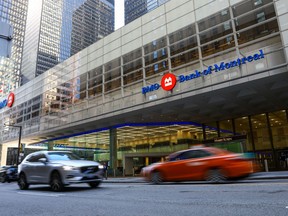 Vehicles pass by the First Canadian Place in the financial district in Toronto on Wednesday, September 29, 2021.