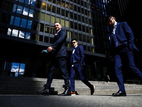 A group of men walk past the Toronto-Dominion Centre on Wellington Street in the financial district in Toronto on Wednesday, September 29, 2021.
