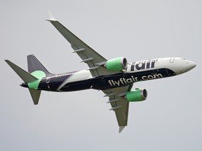 A Flair Airlines Boeing 737 MAX 8 aircraft flying into Edmonton International Airport in 2021.