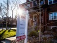 A for sale sign outside a home in Toronto.