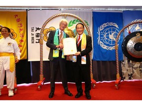 Dr. Hong, Tao-Tze, president of FOWPAL, presents a Certificate to Dr. Aldo Manos, former director of United Nations Environment Programme, for ringing the Bell of World Peace and Love on June 3, 2022 during Stockholm+50.