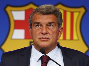 FILE - FC Barcelona club President Joan Laporta pauses during a news conference in Barcelona, Spain, on Aug. 6, 2021. Spain Barcelona's members late on Thursday approved a plan to sale part of its television rights and future revenues from merchandise and licensing in hopes of injecting an immediate 600 million euros ($631 million) into the debt-ridden Spanish club.