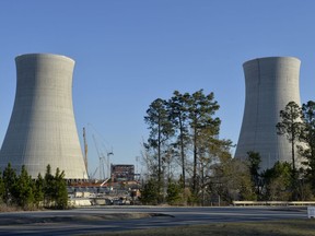 FILE - The cooling towers of the still under construction Plant Vogtle nuclear energy facility in Waynesboro, Ga., Friday, March 22, 2019. One of the owners of the plant announced Saturday, June 18, 2022, that it was freezing its costs and forcing Georgia Power Co. to assume all future overruns, giving up a share of its ownership to Georgia Power.