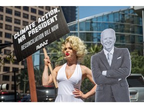 A drag queen dressed as Marilyn Monroe calls on US President Joe Biden to be a climate leader while singing "Happy Summit Dear President!" during an Avaaz protest at the Summit of the Americas on Thursday, June 9, 2022 in Los Angeles. (Jeff Lewis/AP Images for AVAAZ)