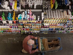 A person pushes a shopping cart in a supermarket in Manhattan, New York City.