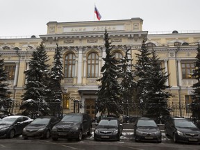 FILE - Cars are parked in front of Russia's Central Bank building in Moscow, Russia, Jan. 30, 2015. Russia's central bank has cut interest rates back to their prewar levels. The bank said Friday June 10, 2022, that inflation and economic activity are developing better than expected despite sweeping Western sanctions imposed in response to the war in Ukraine. The bank lowered its key rate by 1.5 percentage points, to 9.5%.