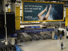 An entrance to Waterloo underground station stands shuttered closed for strike action in Waterloo railway station, in London, Tuesday, June 21, 2022. Tens of thousands of railway workers walked off the job in Britain on Tuesday, bringing the train network to a crawl in the country's biggest transit strike for three decades.