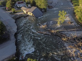 A house sits in Rock Creek after floodwaters washed away a road and a bridge in Red Lodge, Mont., Wednesday, June 15, 2022.