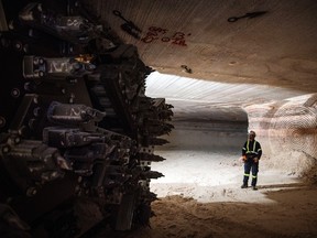 A miner stands near the cutting head of a digger near an active mining wall at the Nutrien Ltd. Cory potash mine in Saskatoon, Sask.