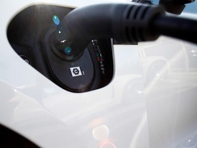 A charging plug in a Porsche Taycan electric vehicle at the Porsche SE showroom in Berlin, Germany.