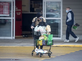 A shopper leaves a Metro grocery store in Mississauga, Ont.