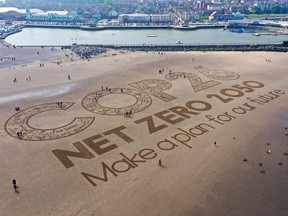 A giant sand artwork adorns New Brighton Beach to highlight global warming and the Cop26 global climate conference in Wirral, Merseyside.