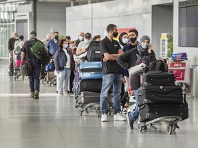 Travellers wait in the queue at Toronto Pearson Airport's Terminal 3.