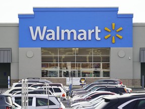 FILE - Cars fill up a parking lot in a Walmart location in Philadelphia on Nov. 17, 2021. The Federal Trade Commission said Tuesday, June 28, 2022, that it has sued Walmart for allegedly allowing its money transfer services to be used by scam artists who stole "hundreds of millions of dollars" from customers.