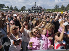 FILE - In this May 26, 2018, file photo, people listen to Michael Franti perform at the BottleRock Napa Valley music festival in Napa, Calif. Summer music festivals can be a once-in-a-lifetime experience, but costs can be excessive for many fans. With expenses for food, drinks, outfits, flights and hotels on top of the ticket price, budgeting for a festival can outperform even the best lineups. Taking advantage of credit card rewards for entertainment purchases, planning ahead for hidden costs, using a zero-interest payment plan or even partnering with festival brands through social media may make these special events more affordable. If your dream festival experience is still out of reach, don't worry -- there will always be another one.