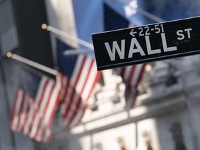 FILE - A sign for Wall Street hangs in front of the New York Stock Exchange, on July 8, 2021. Stocks are opening lower on Wall Street Thursday, June 9, 2022, putting major indexes into the red for the week.