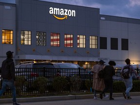 FILE - People arrive for work at the Amazon distribution center in the Staten Island borough of New York, on Oct. 25, 2021. A federal labor board has denied Amazon's request to bar the public from a hearing on the company's bid to overturn a historic union win at one of its Staten Island, New York, warehouses.