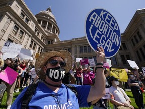 Abortion rights demonstrators attend a rally at the Texas Capitol, Saturday, May 14, 2022, in Austin, Texas. When a leaked draft decision signaled the end to federal protections for the right to an abortion in the U.S., donors clicked on donations buttons and mailed checks in a spasm of fury. The "rage giving" has given abortion funds a temporary financial boost.