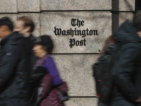 FILE - People walk by the One Franklin Square Building, home of The Washington Post newspaper, in downtown Washington on Feb. 21, 2019. The Washington Post has fired reporter Felicia Sonmez, who has triggered a vigorous online debate this past week over social media policy and public treatment of colleagues.