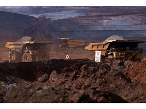Trucks transport iron ore mined at Vale's Brucutu mine in Barao de Cocais, Brazil.  Bloomberg